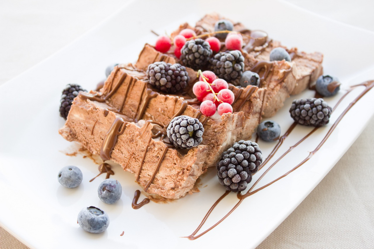 Delicious cake with chocolate drizzle and fruit